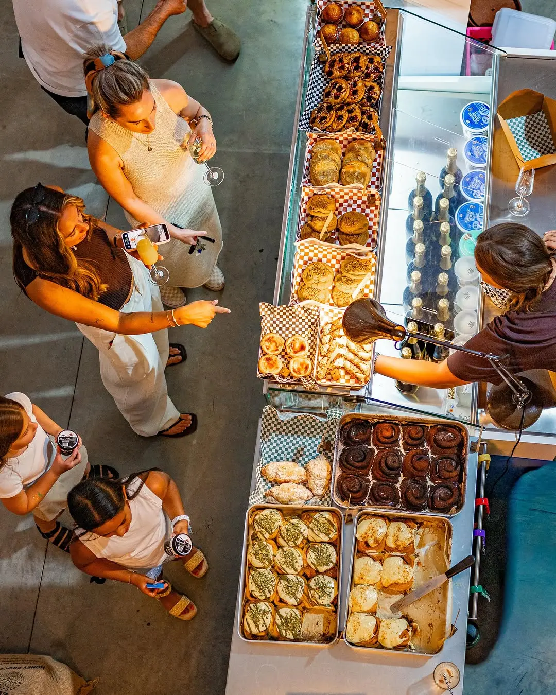 Looking down on the 45 Fuel deli counter on opening day, trays of pastries, focaccia and local ice creams