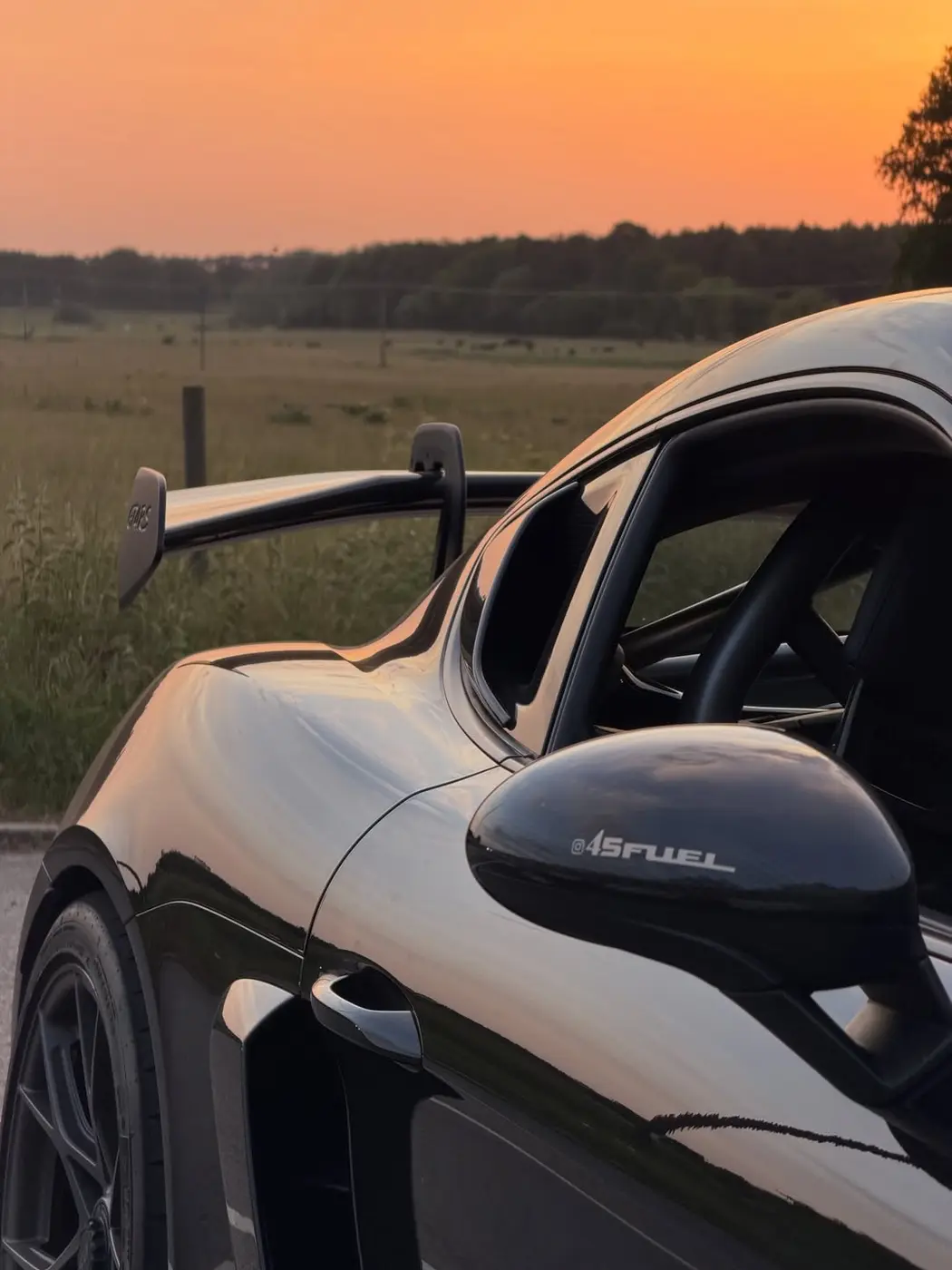 A Porsche 718 Cayman GT4 RS photographed at sunset