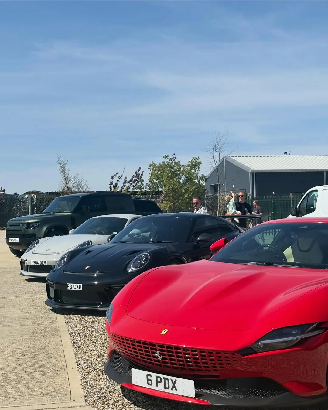 Supercars parked in a row outside 45 Fuel on opening day